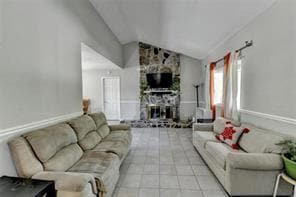 Living area with lofted ceiling and a fireplace