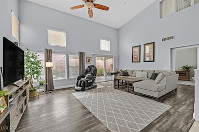 Living room featuring a ceiling fan, wood finished
