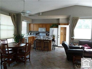 Open kitchen features center island, built-in micr
