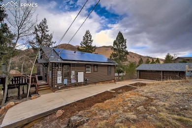 Rear view of house with faux log siding, a garage,