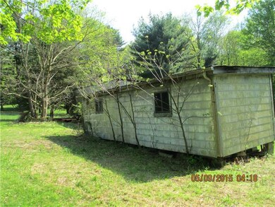 Exterior Front. Extra shed and storage trailer are
