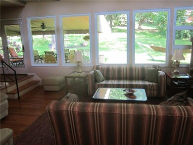 Sunken livingroom/wall of new windows! Covered pat