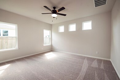Carpeted empty room featuring baseboards and ceil