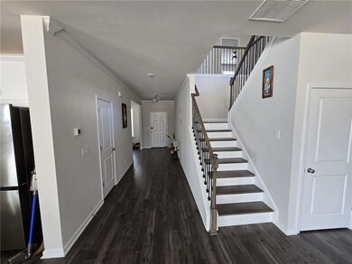 Foyer entrance featuring visible vents, baseboards