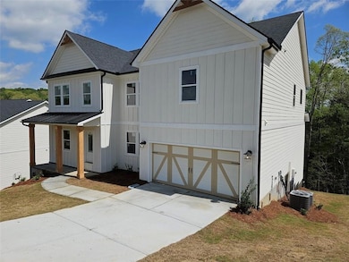 Modern farmhouse with a garage, covered porch, board and batten siding, cooling unit, and concrete driveway