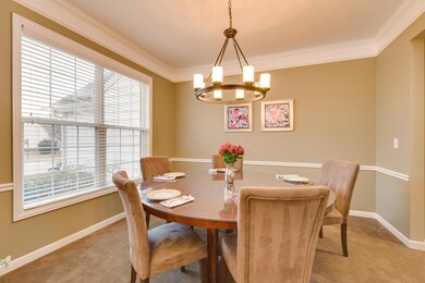 Dining Room with 2 piece crown molding, chair rail and upgraded light fixture.