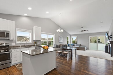 Large open concept with vaulted ceilings and an abundance of overhead lighting.