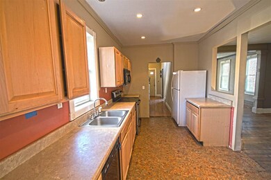 Galley style kitchen with maple cabinets