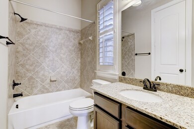 This guest bathroom is located on the first floor and is part of the guest suite.