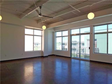Unfurnished room with a ceiling fan, beam ceiling