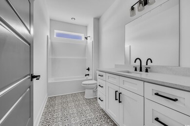 Bathroom with vanity and washtub / shower combination