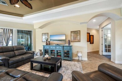 Living room with a raised ceiling and ornamental m