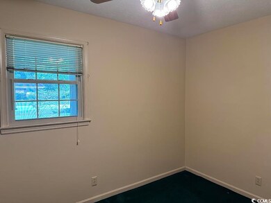 Spare room featuring ceiling fan and baseboards