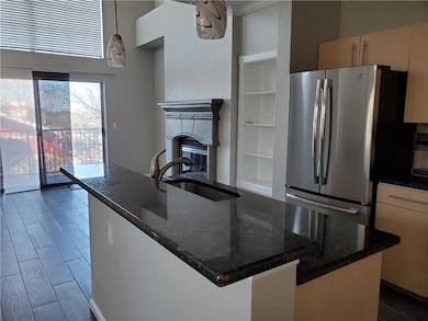 Kitchen featuring freestanding refrigerator, a si