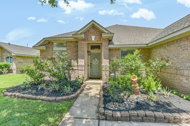 Beautiful landscaping, brick, and covered door way