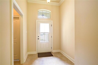 Extended tile foyer with beautiful transom window