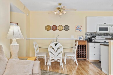 Dining room with ceiling fan and light wood-type f