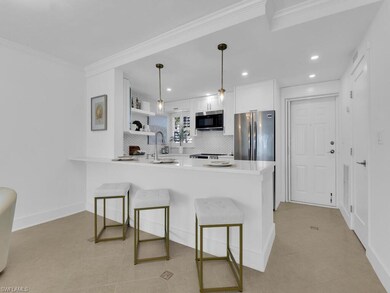 Kitchen featuring backsplash, appliances with stai