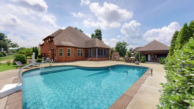 Imagine spending the hot summer season in your cool pool!  Pool house features full kitchen (refrigerator stays) and half bath, with 10x8 storage area.  Built in fireplace and grill for entertaining all your family and friends!