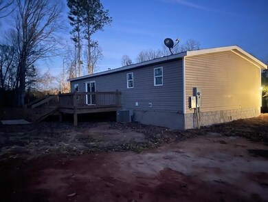 Back of house featuring central air condition unit