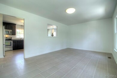 Family room with porcelain tile floor.