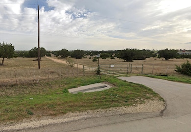 View of yard with a rural view, a gate, and fence