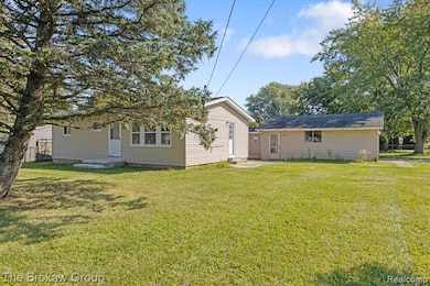 Back of property with a lawn