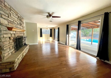 Unfurnished living room with ceiling fan, wood fin