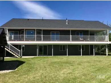 Back of house featuring covered patio & deck,  a yard and stairs