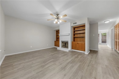 Unfurnished living room with visible vents, a bric
