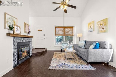 Living room featuring a ceiling fan, baseboards, w