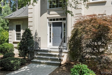 View of exterior entry featuring stucco siding
