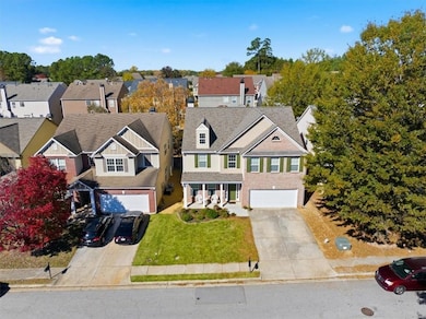View of front of property featuring concrete driveway, a residential view, a front lawn, and roof with shingles