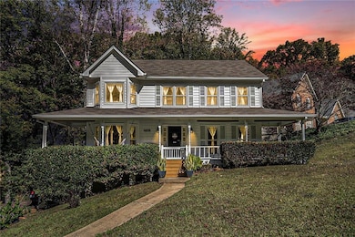 Farmhouse with covered porch and a lawn