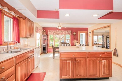 The kitchen has a center island with a breakfast b