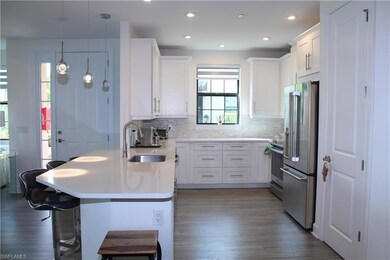 Kitchen with stainless steel appliances, dark wood
