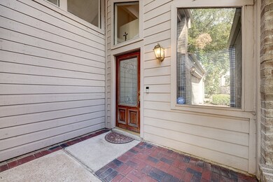 Front door is nestled behind garage entrance, this