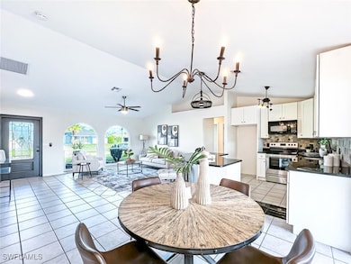 Dining room featuring  a chandelier, vaulted ceili