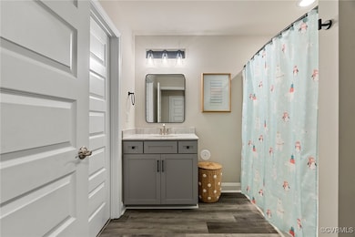 Bathroom featuring vanity and wood-type flooring