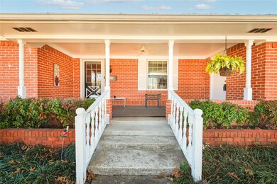 View of exterior entry with covered porch
