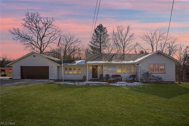 Ranch-style house with a lawn and a garage