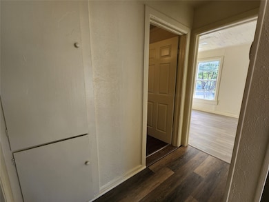 Hallway with dark wood-type flooring