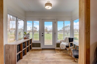 Step through the front door into a beautiful sunroom, featuring stunning floors and a wainscoting ceiling that sets the tone for the home's character.