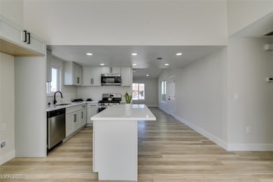 Kitchen featuring stainless steel appliances, a si