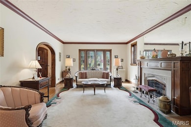 Living area with Stone Fireplace, Hardwood floors, beautiful Stain Glass and Millwork.