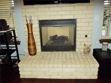 Beautiful gas fireplace with brick surround and he
