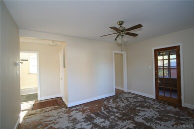 Living room looking into the hallway, with a cased opening to the kitchen and door to sunroom.