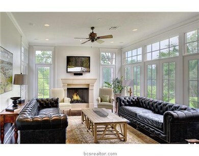 Living Room. Enjoy the spectacular view from this living area surrounded by windows and open to the kitchen and breakfast area.  Wonderful hardwood floors flow through this area with many extra features.