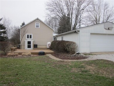 Large garage, deck and sunroom to right between ho
