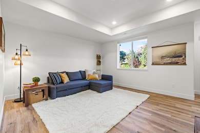 Living room with light wood-style floors and recessed lighting